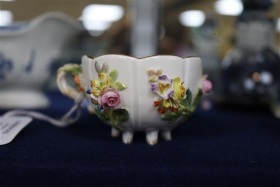 A Meissen flower encrusted cup and saucer